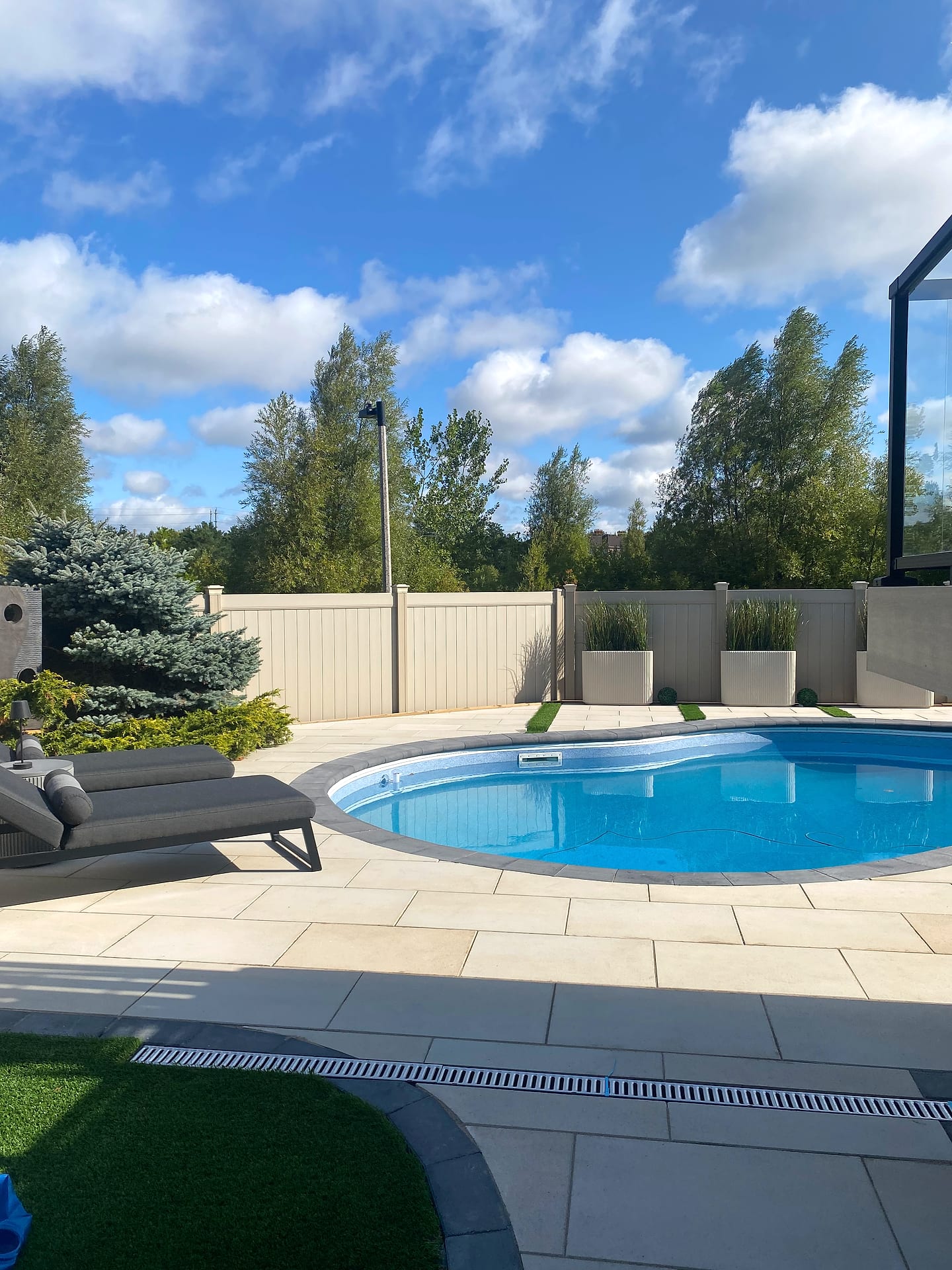 Luxury backyard pool and patio by A-Z Landscaping